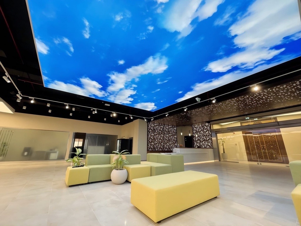 Printed sky stretch ceiling in cultural venue lobby